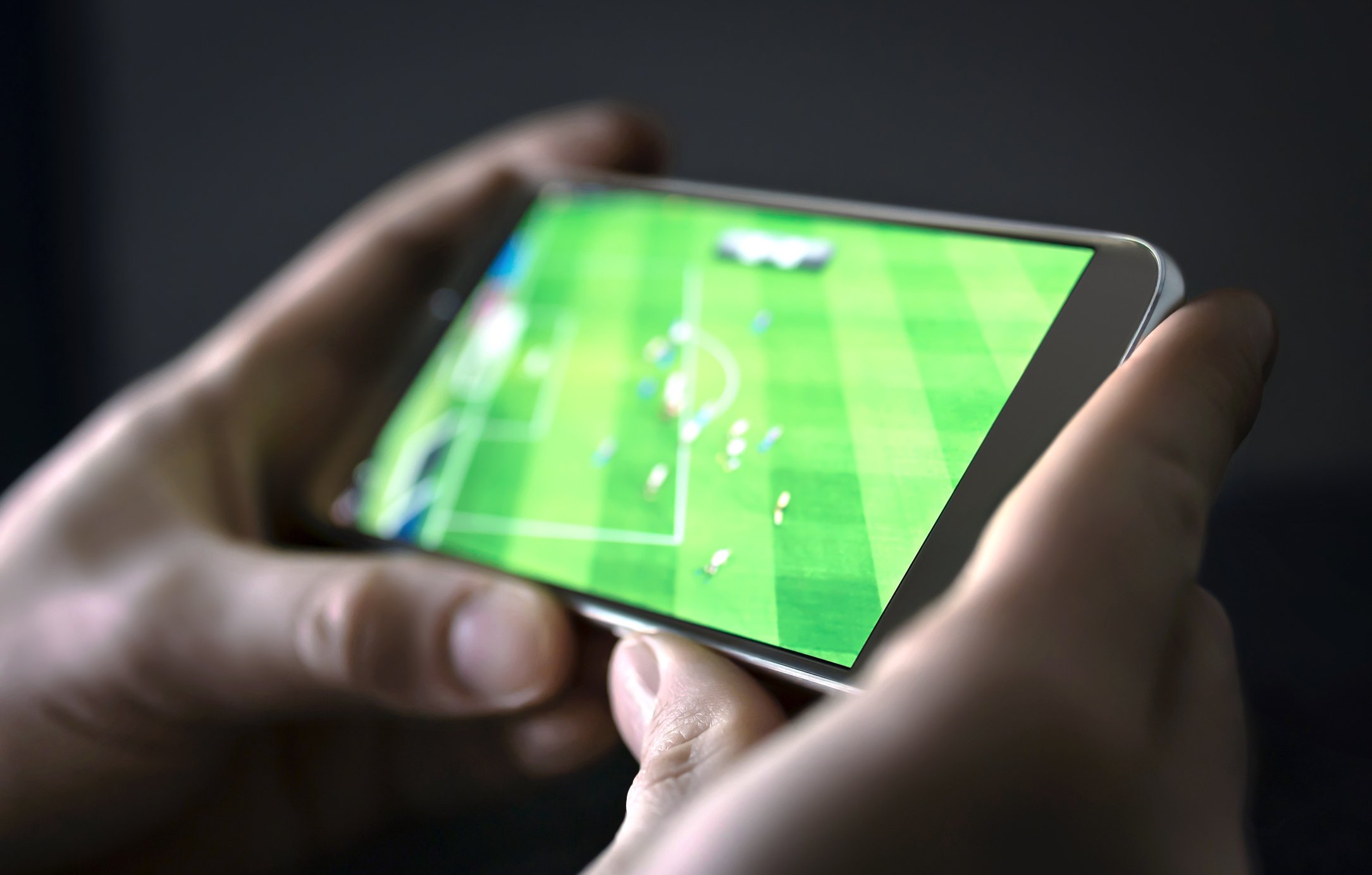fan watching sports on smartphone