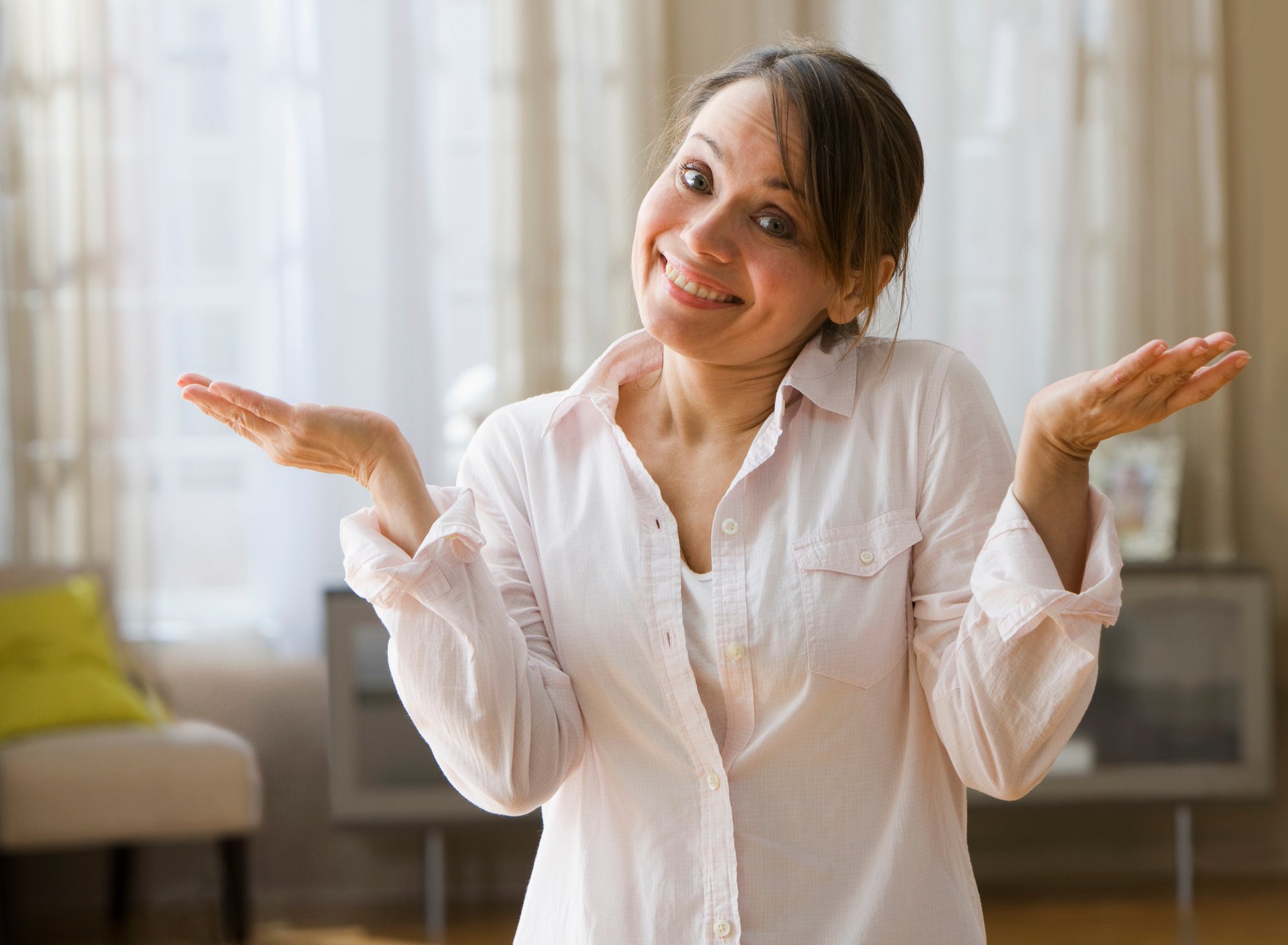 Smiling woman shrugging