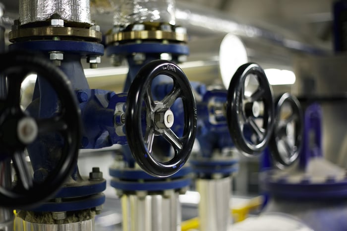 A close up view of steel pipes and industrial valves.