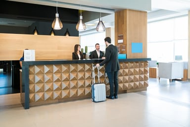 Guest checks in at a hotel front desk