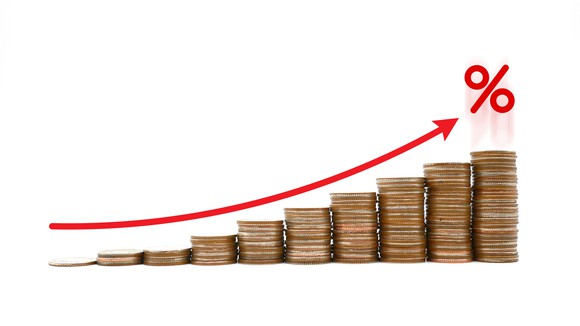 Stacks of coins and an up arrow representing rising sales.