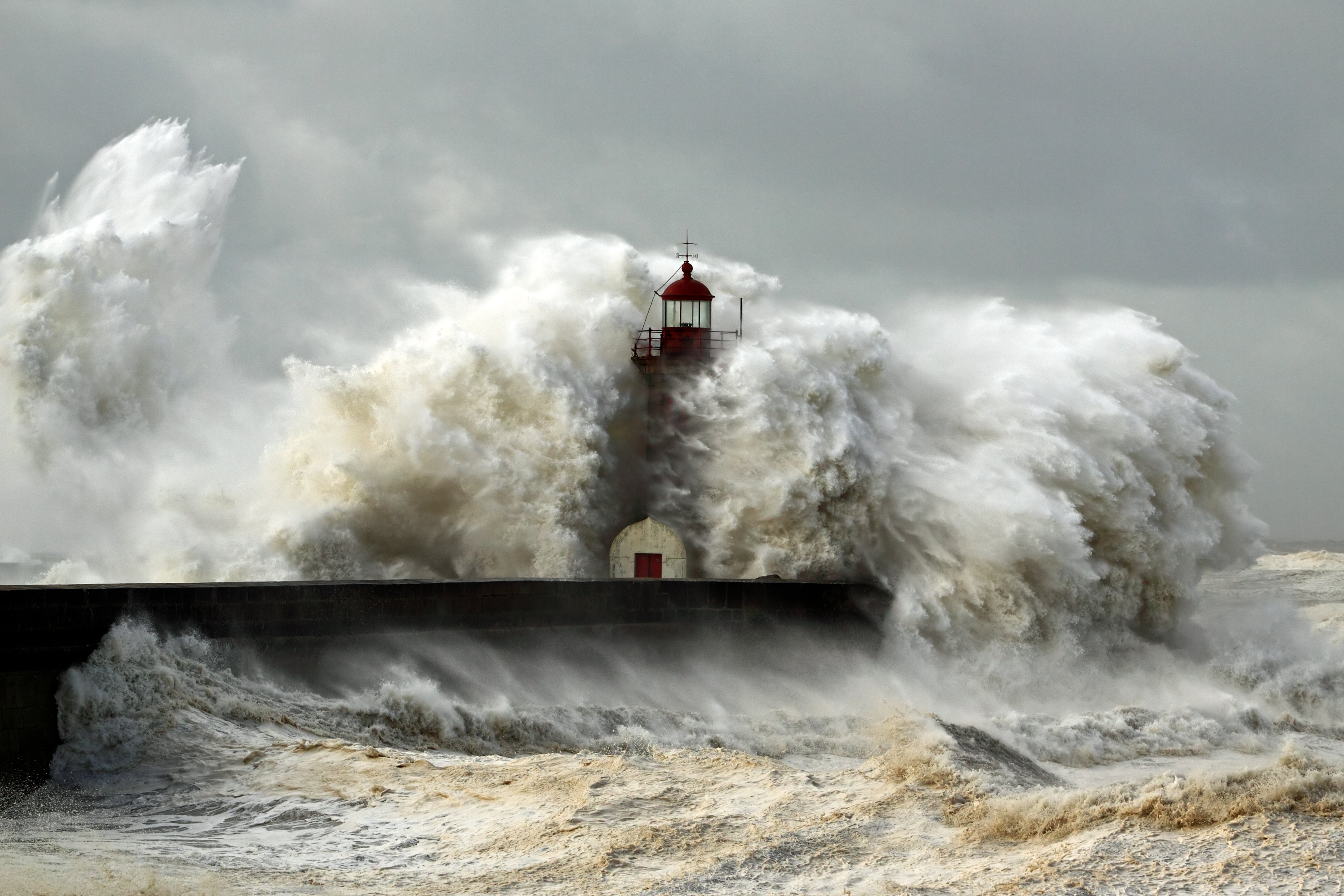 Lighthouse being hit by large wave