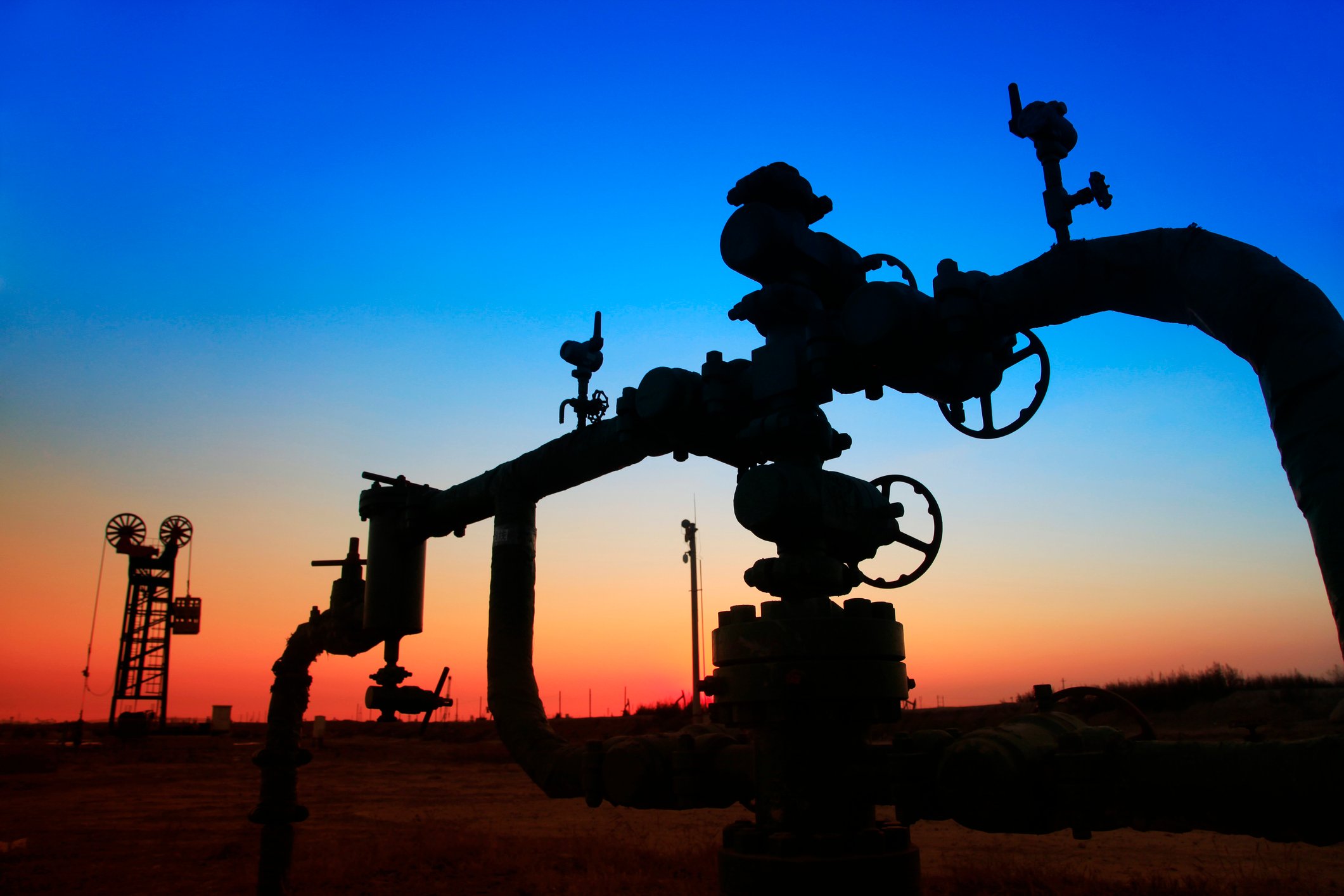 An oilfield pipeline at sunset