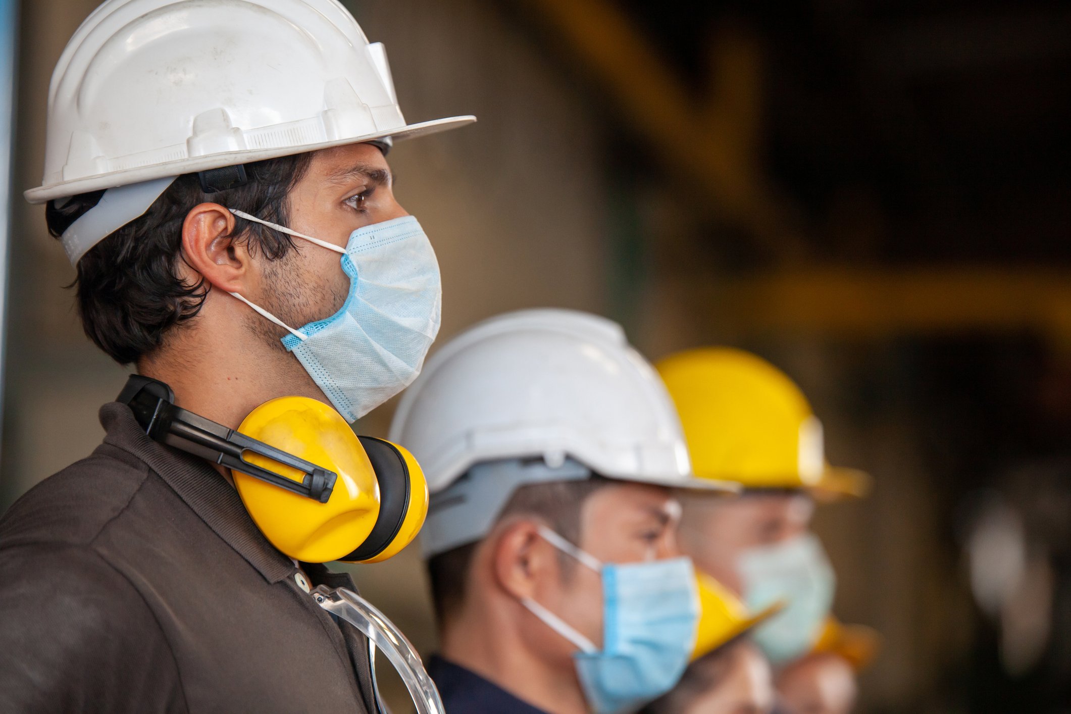 factory workers wearing ppe including face masks