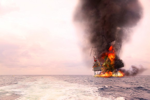 An offshore oil rig on fire.