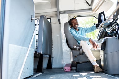 smiling older male bus driver