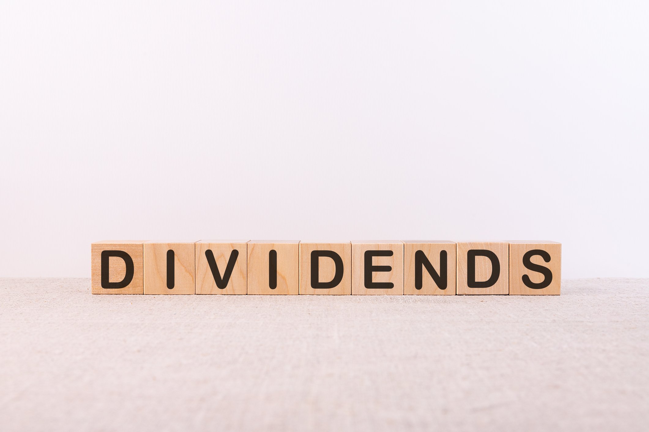 Letter blocks spelling the word "dividends."