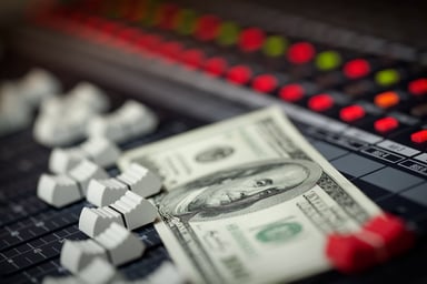 Money on a music mixing board