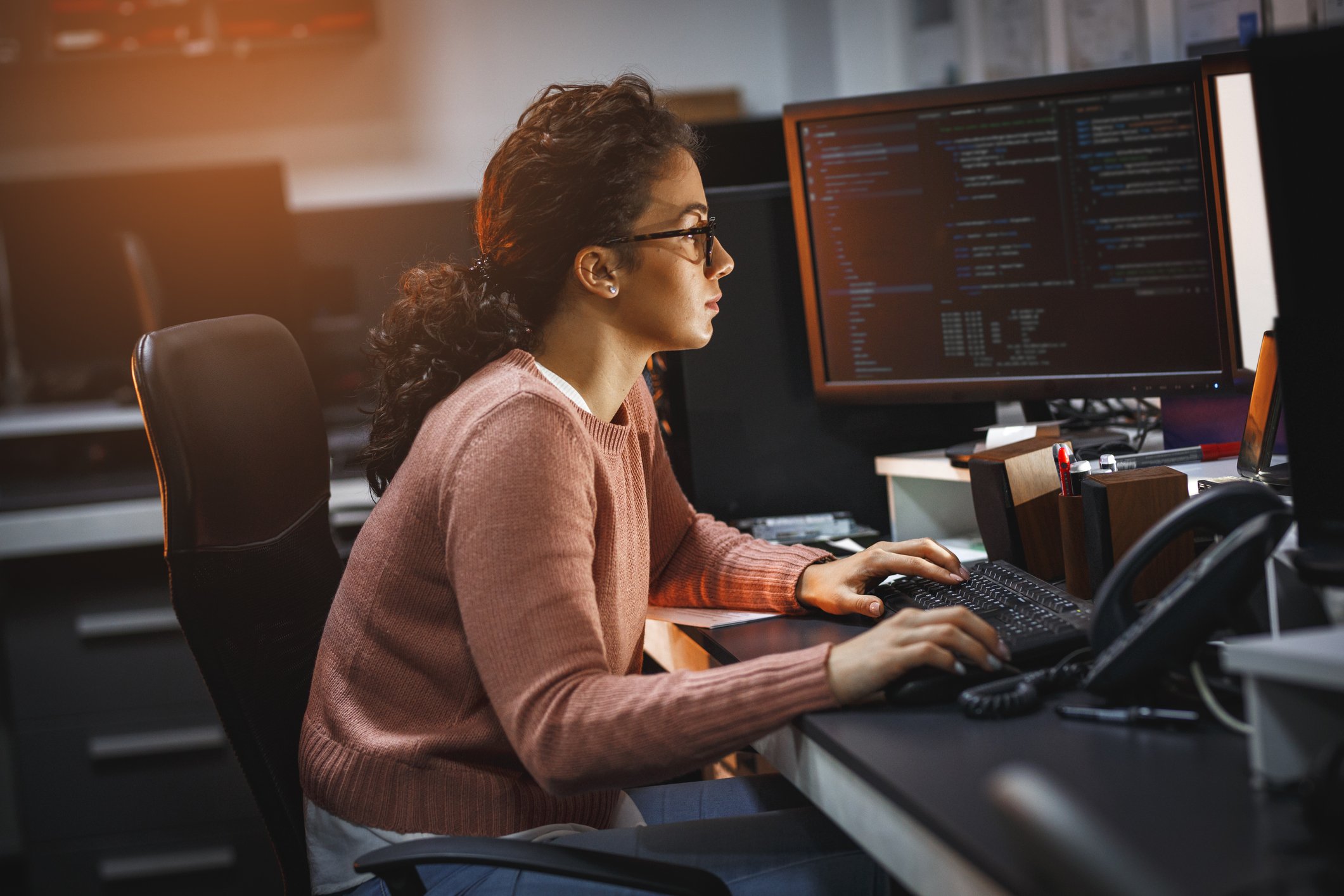 Young woman working at a computer station 