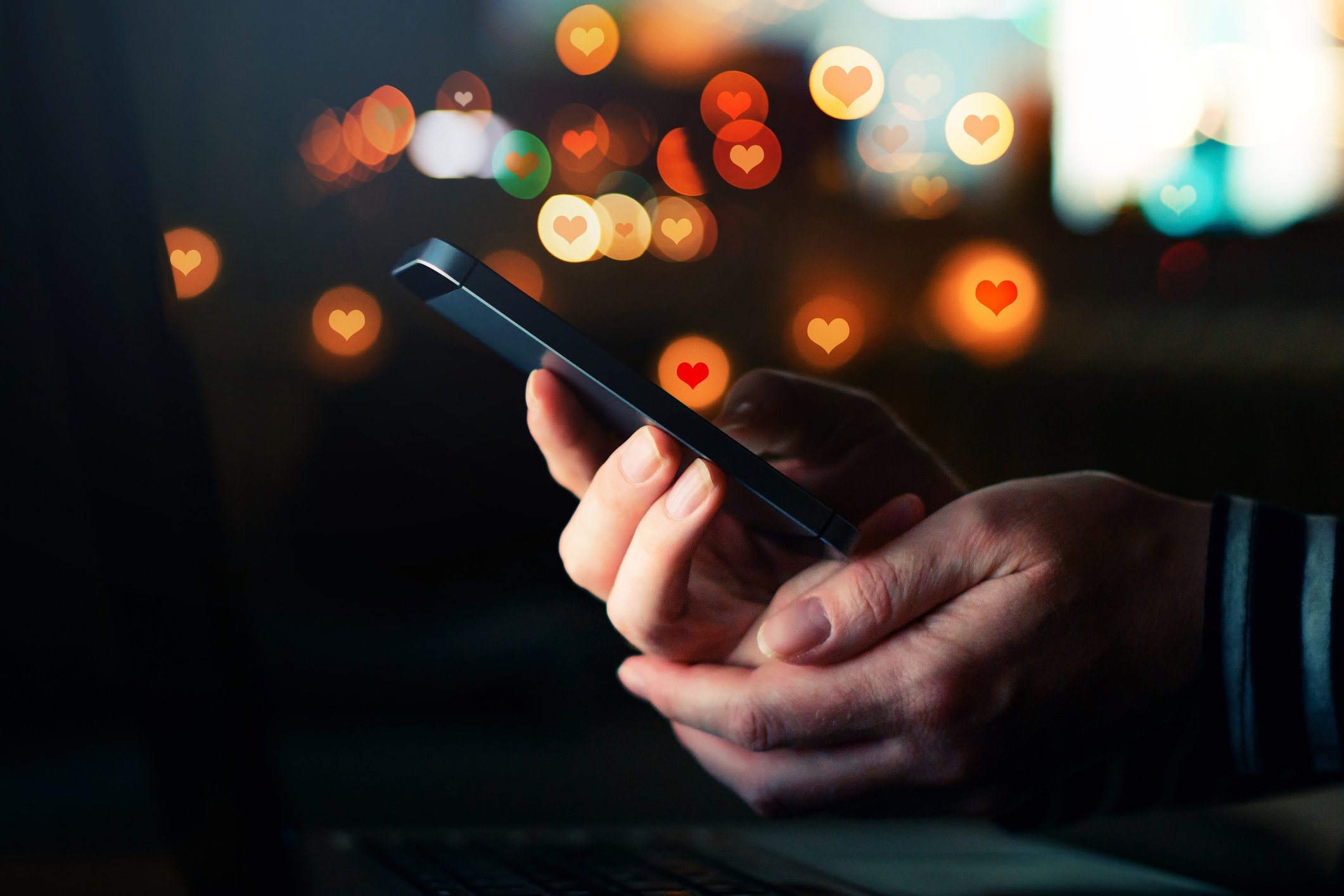 A man uses a dating app on a smartphone.