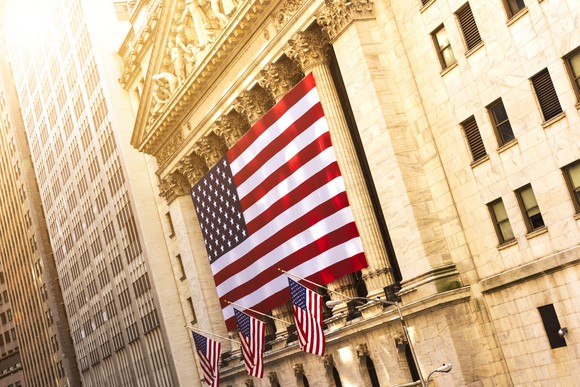 A giant flag draped in front of the New York Stock Exchange