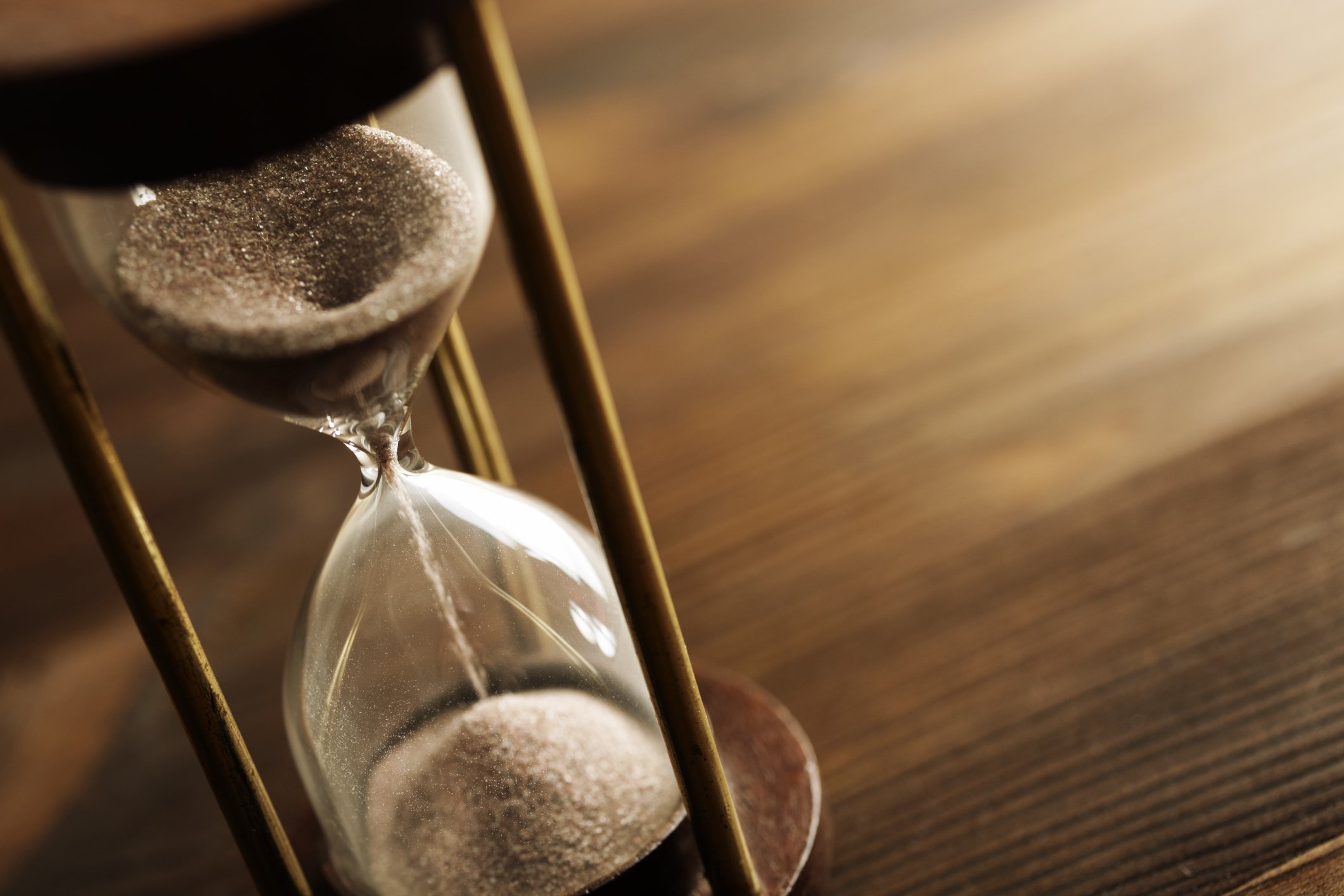 A half-emptied hourglass on a table. 
