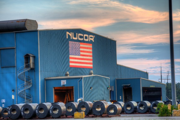 Nucor's Gallatin, KY mill from the outside with Nucor sign and American flag