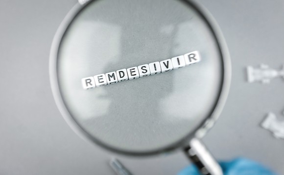 Magnifying glass over blocks spelling remdesivir