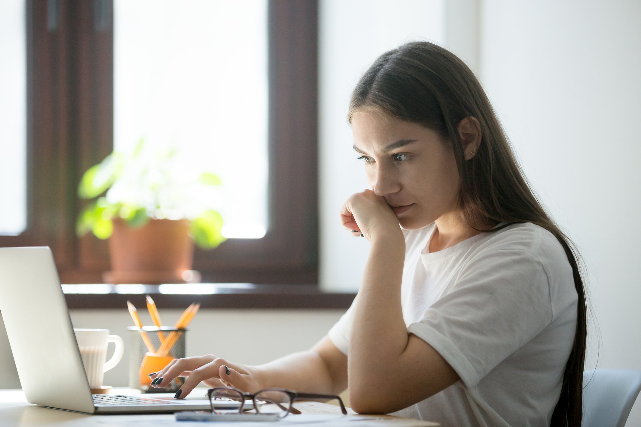 A woman researching on her laptop.