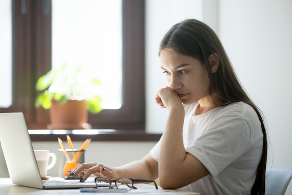 A woman researching on her laptop.
