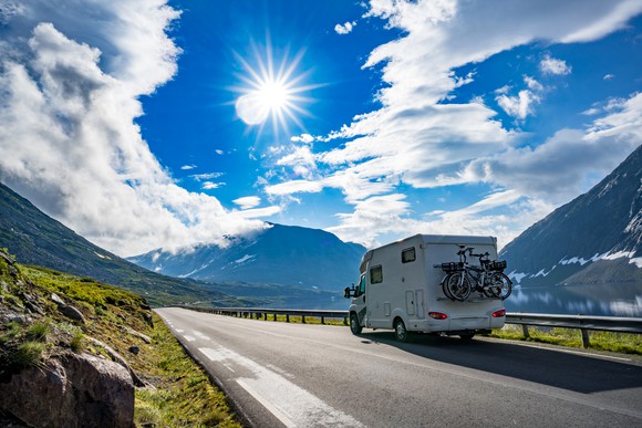 An RV camper on a mountain road.