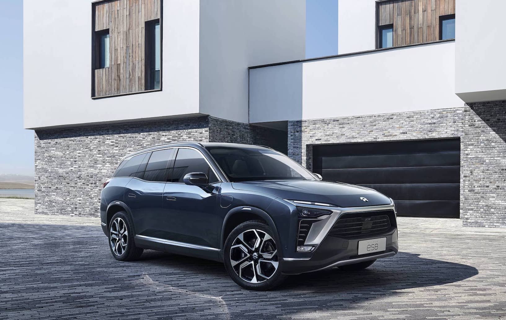 A blue NIO ES8, an upscale three-row electric SUV.