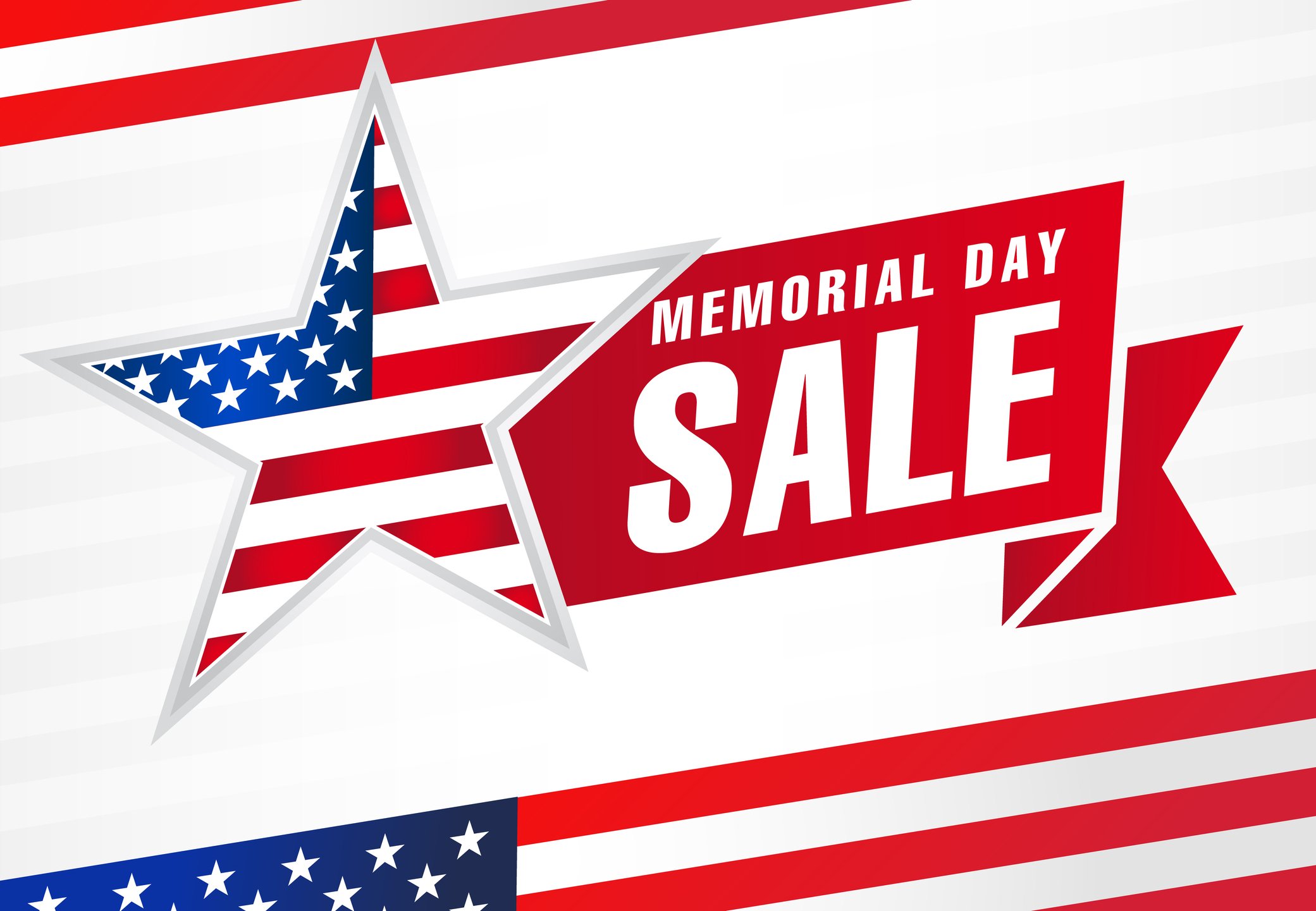 A sign draped in American flag colors saying Memorial Day Sale. 