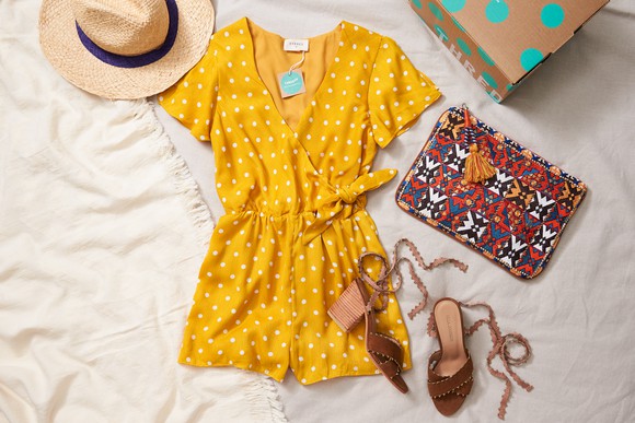 some of the women's apparel available from ThreadUp is laid out on a canvas background.