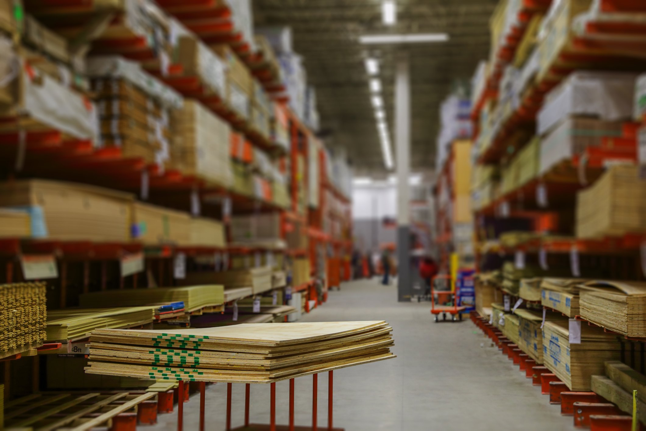 An aisle within the lumber section of a home improvement store.