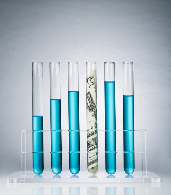 Rolled-up US paper banknote in a test tube rack