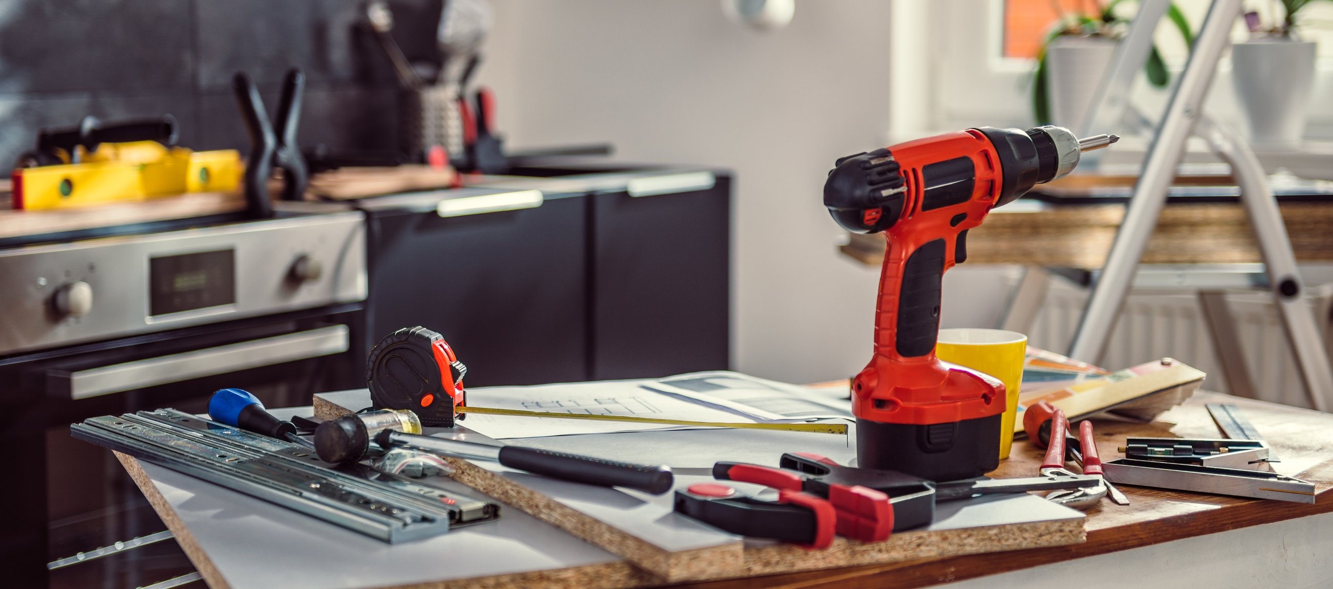 Drill and tools on a table within the kitchen