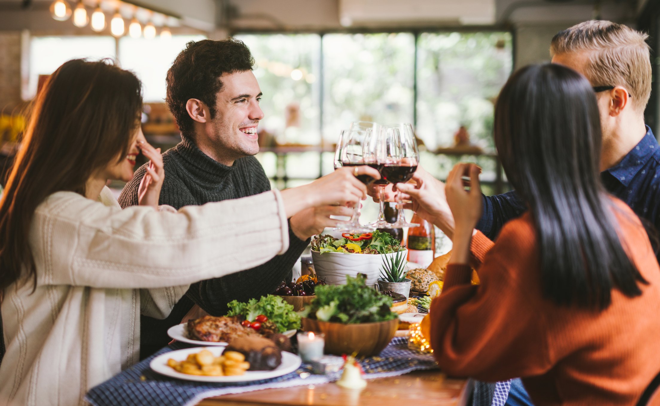 Four people enjoying a meal at a restaurant