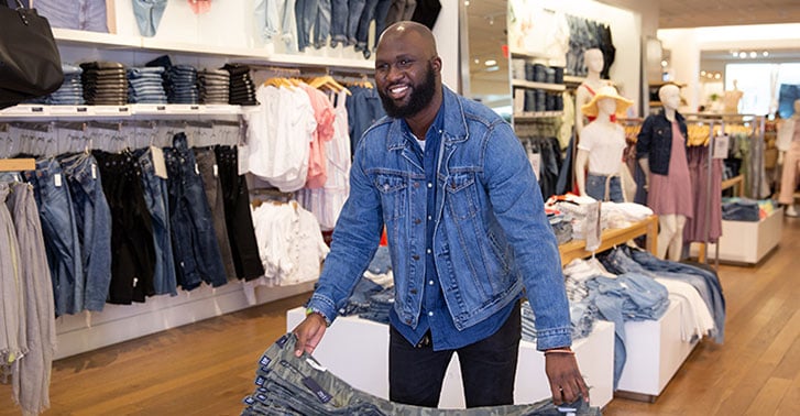 Gap employee folding clothes.