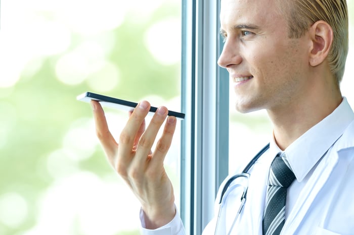 A doctor holding a mobile phone.