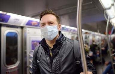Masked man riding subway_GettyImages-1217377735