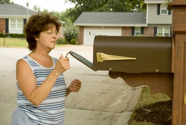 Woman opening mailbox_GettyImages-121347349