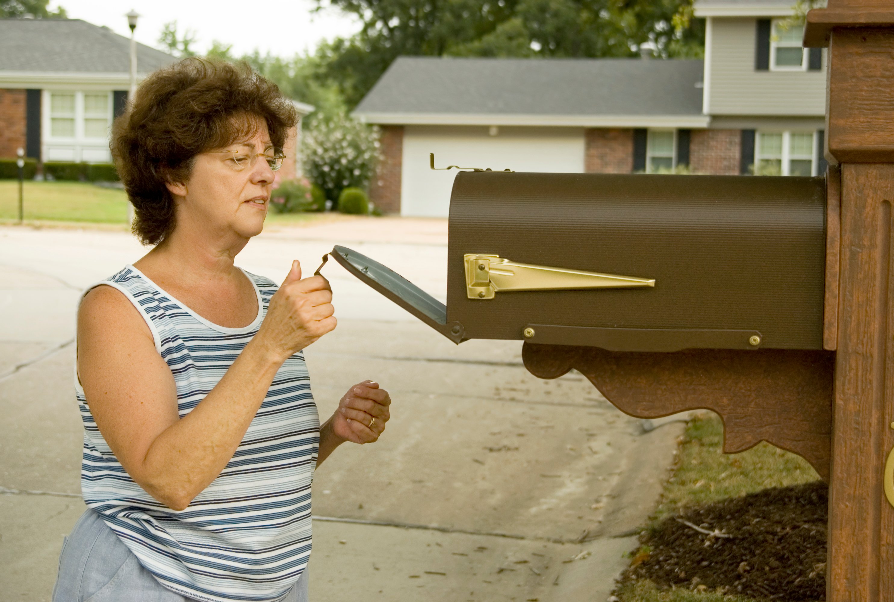 Woman opening mailbox