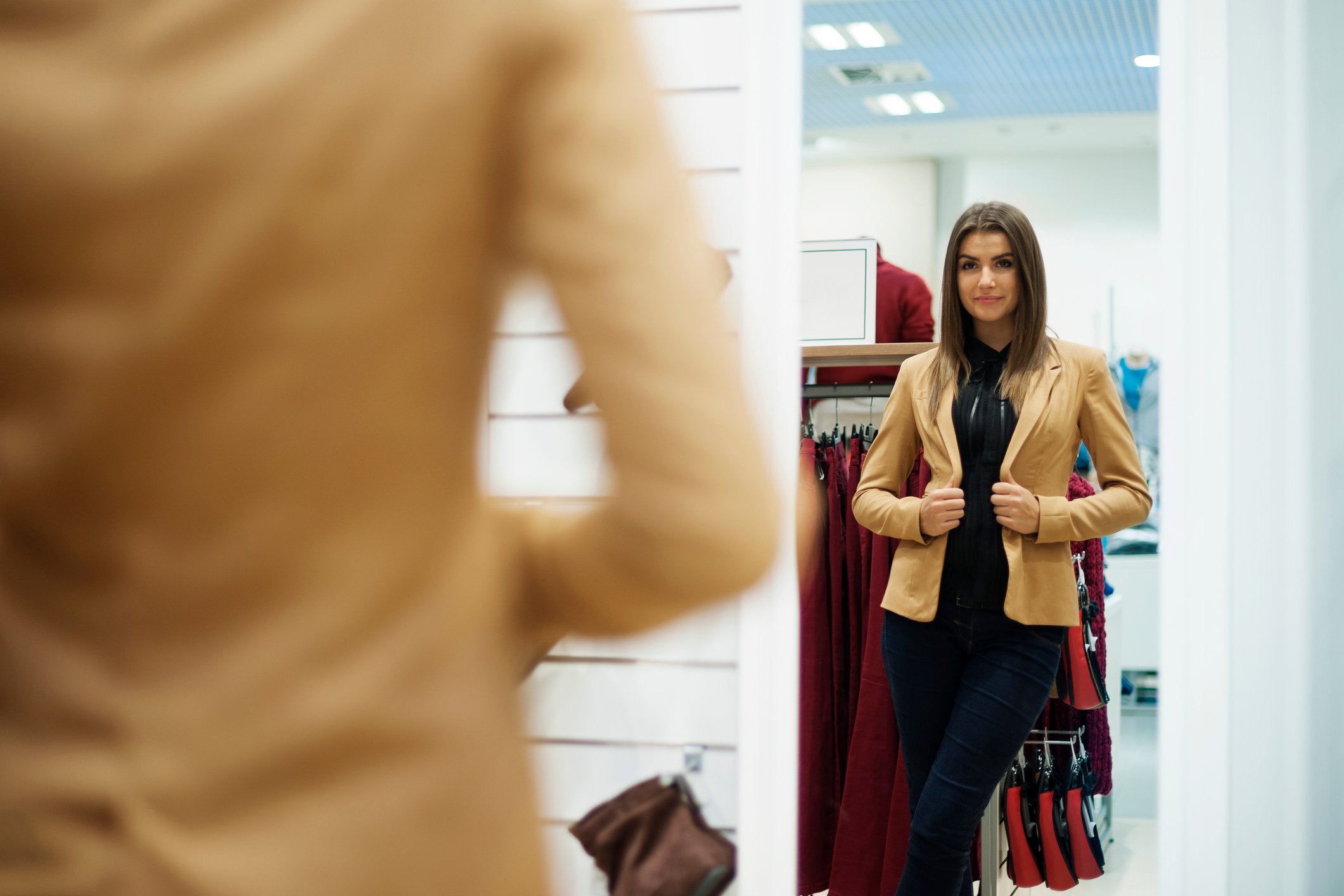 A woman trying on clothing.