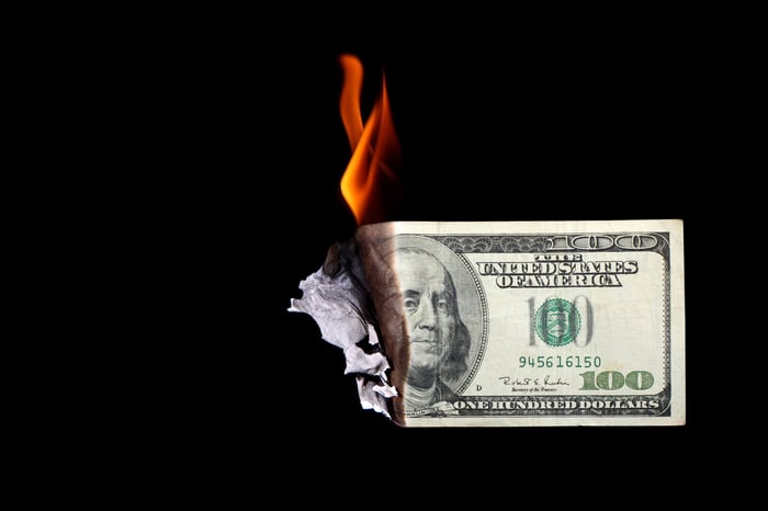 A one hundred dollar bill burning.