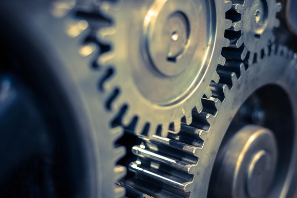 A close-up of gears turning. 