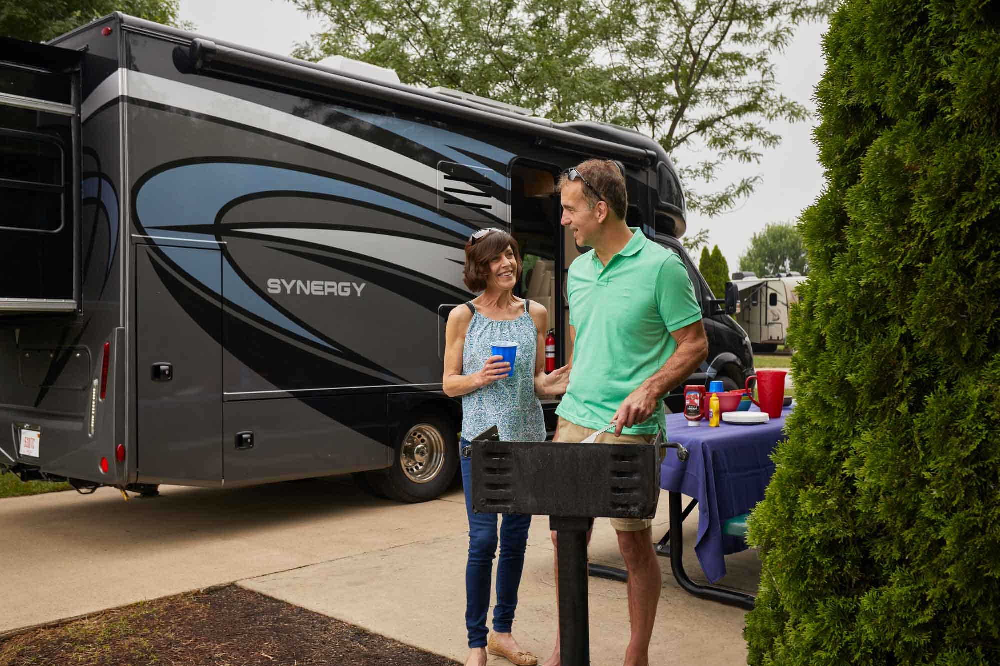 Thor RV with happy couple in front of it.