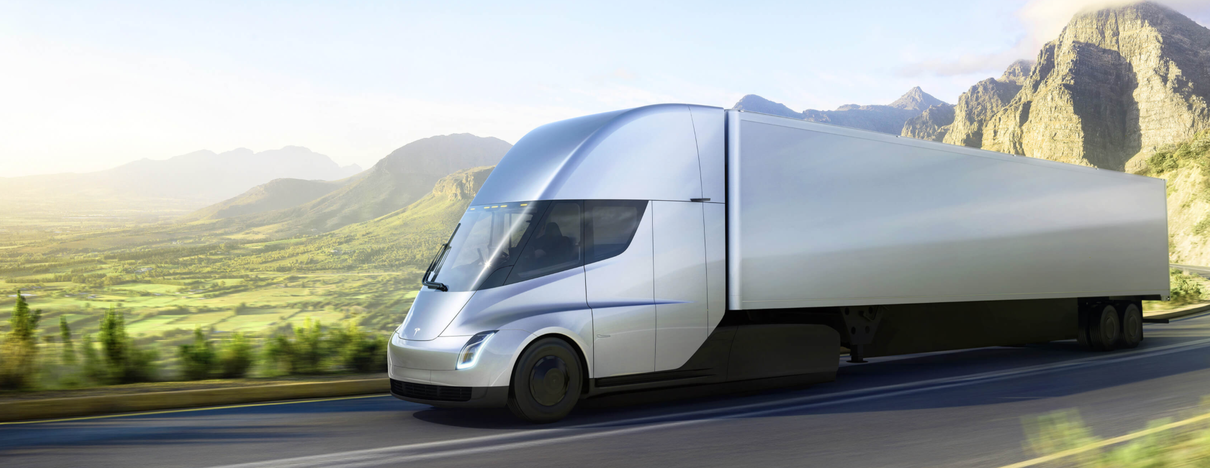 The Tesla Semi drives on a country highway.