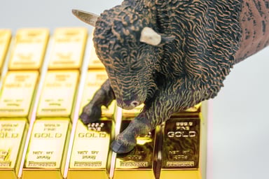 bull figurine on gold bars