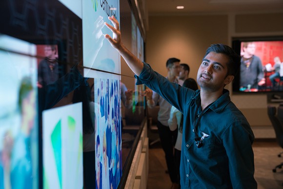 Man watching images on CenturyLink screens