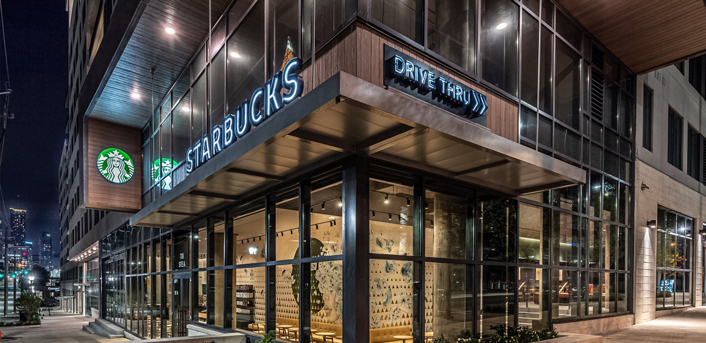 A Starbucks small-format store with a sign saying Drive Thru