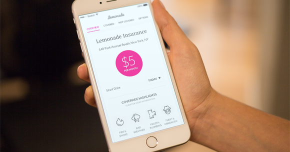A hand holding a smart phone with Lemonade Insurance displayed