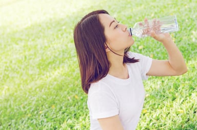 sparkling water bottle woman getty