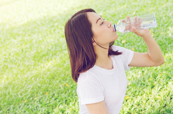 Woman drinking out of plastic bottle
