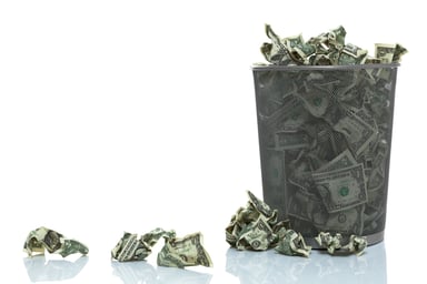 Trashcan full of crumpled money