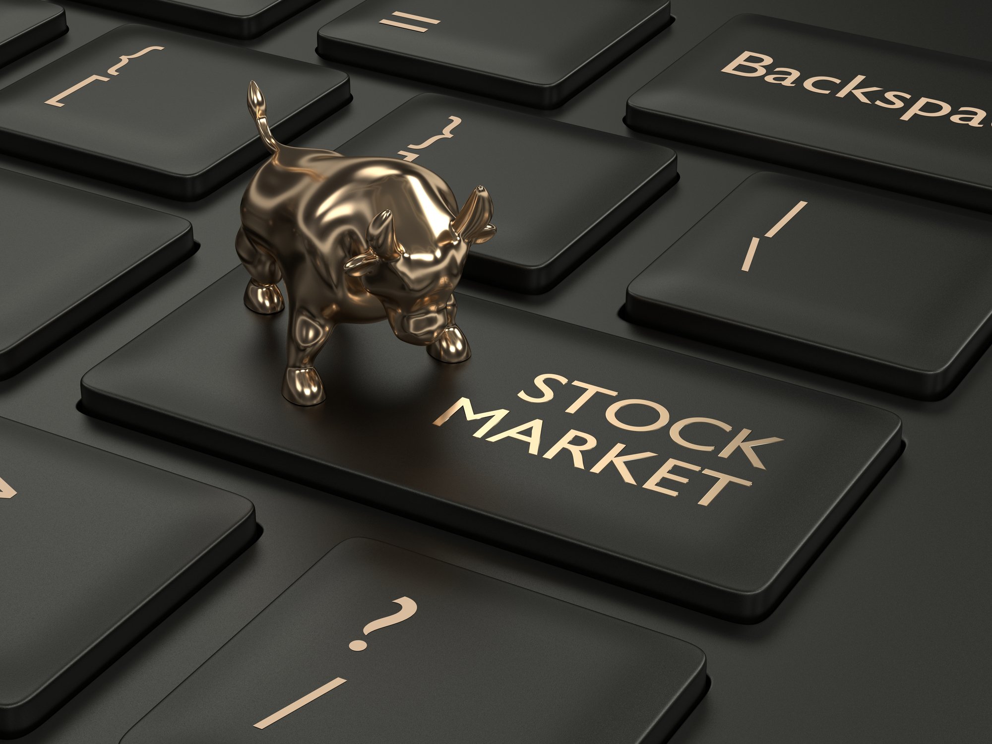 Tiny gold bull on top of stock market key on a PC keyboard.