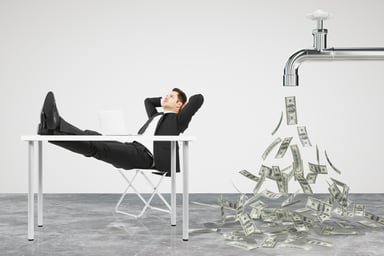 Businessman, money flowing from faucet