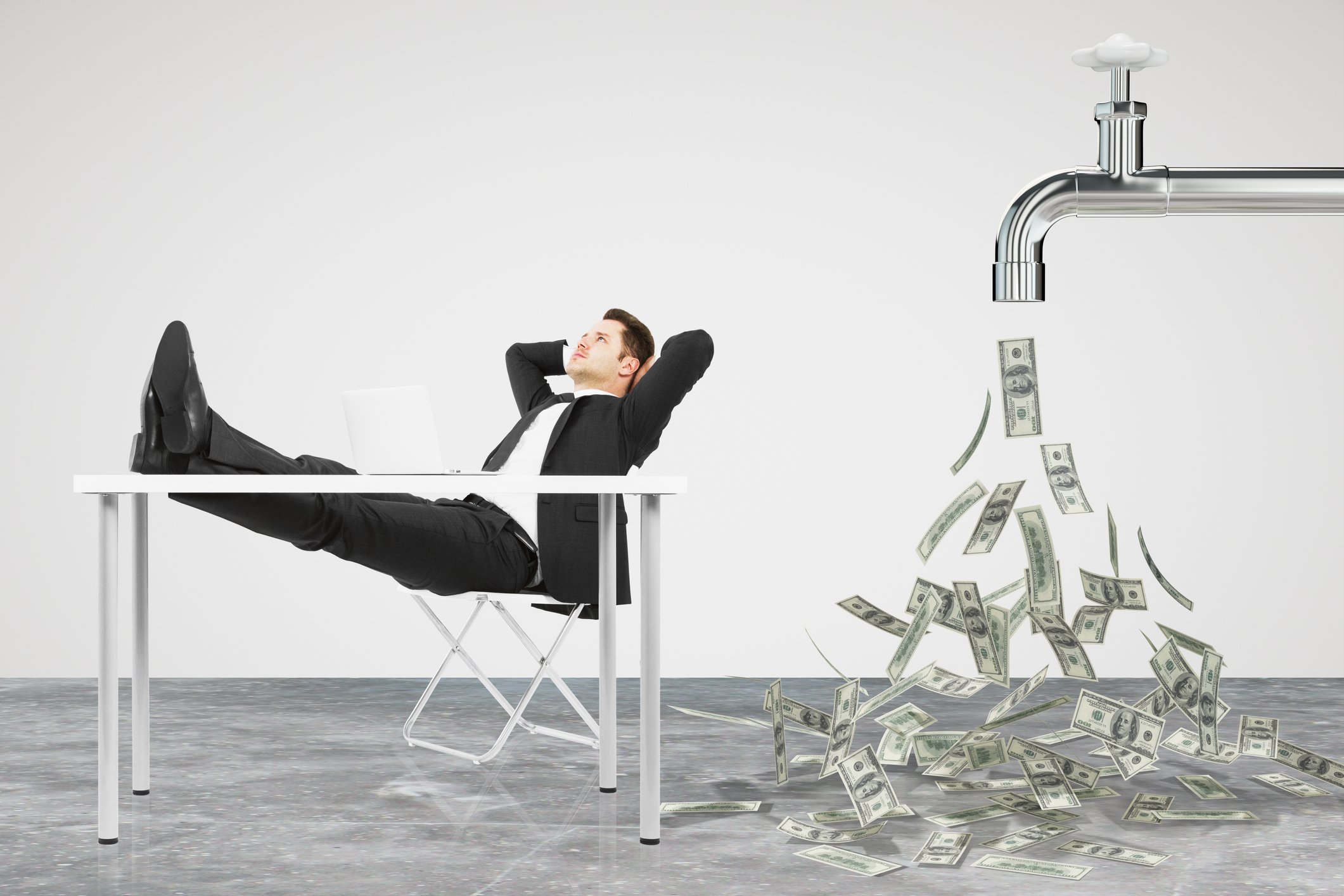Businessman sitting with his feet propped up on table and money flowing out of a giant faucet behind him