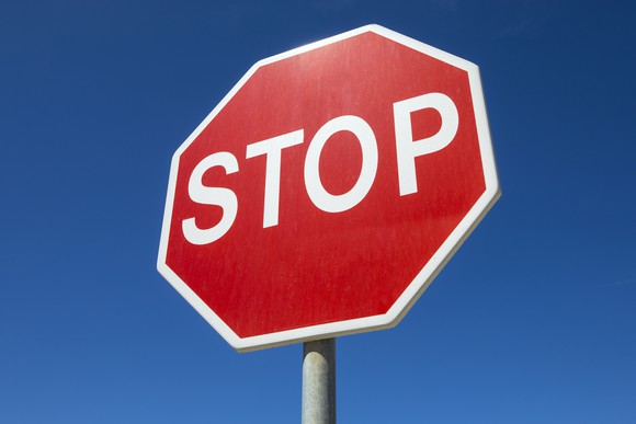 Regular, eight-sided stop sign with white letters on red background