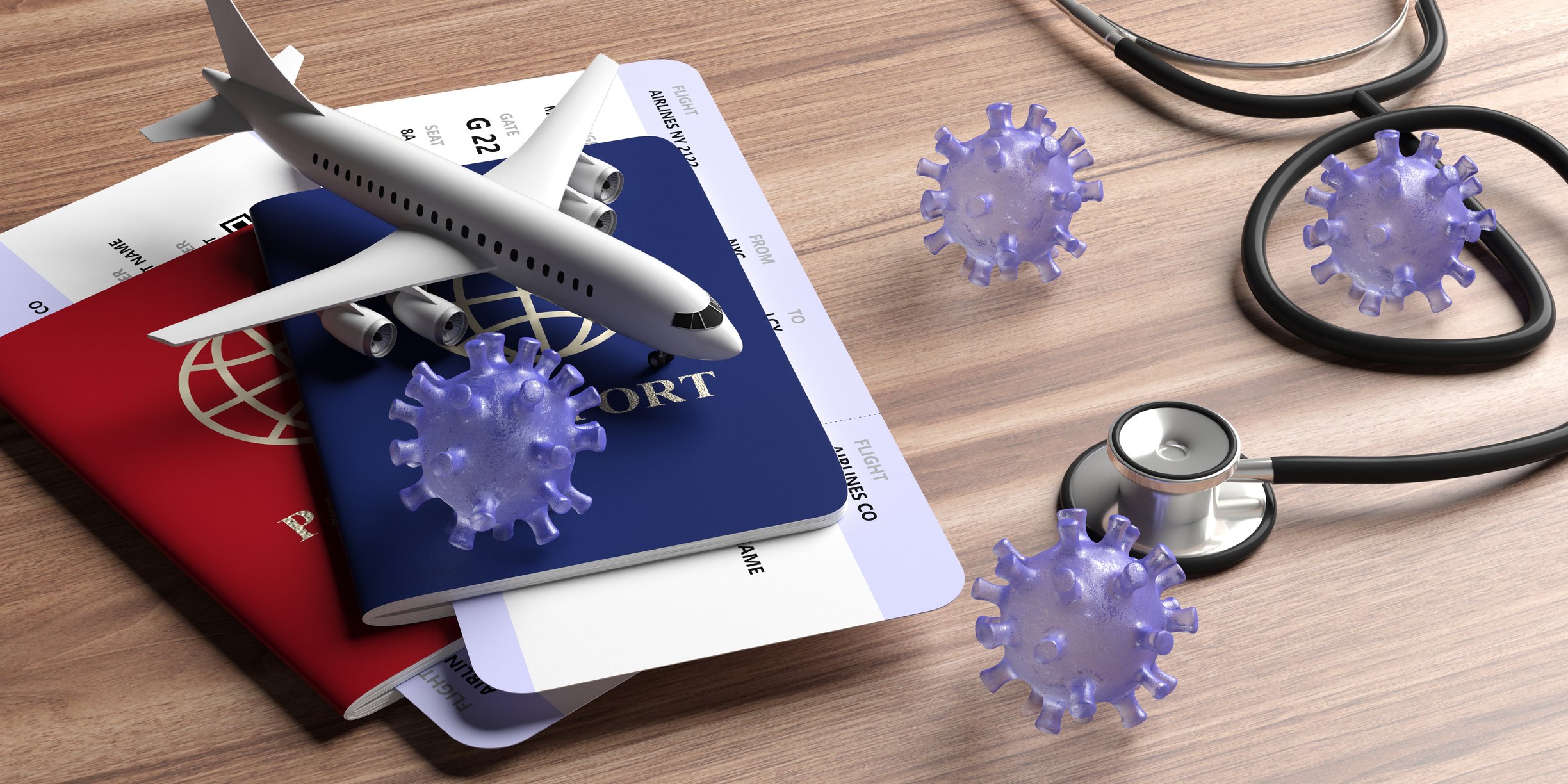 A passport, a model airplane, and a stethoscope on a table top with coronavirus models.